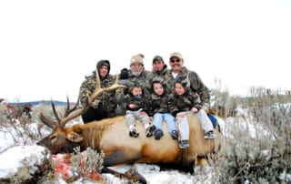 group posing with elk and horns