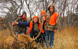 group posing with elk and horns