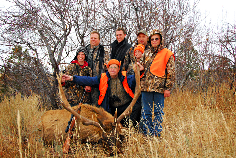 group posing with elk and horns