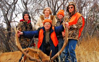 group posing with elk and horns