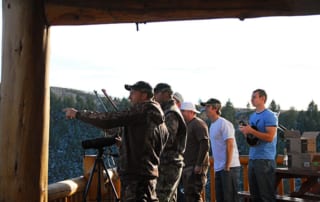 group of men at lodge pointing to someting on the groups