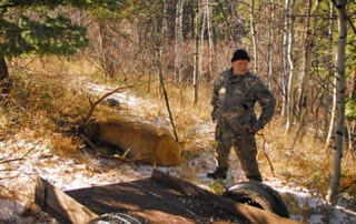 man with downed elk