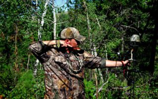 man drawing an arrow with a bow