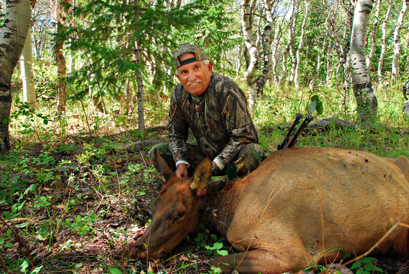 man posing with an elk