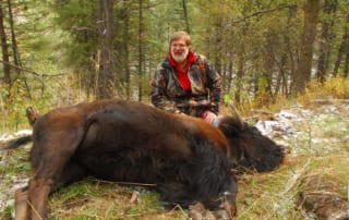 man posing with a buffalo