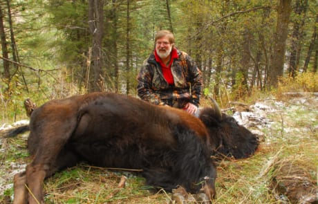 man posing with a buffalo