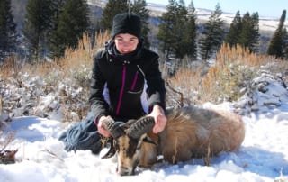 woman posing with a ram