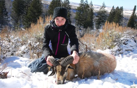 woman posing with a ram