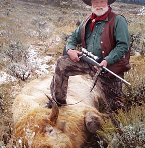 man posing with a buffalo