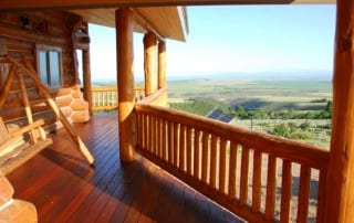 deck with swing and view of hills