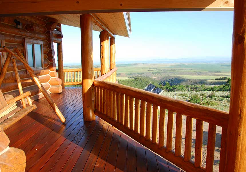 deck with swing and view of hills