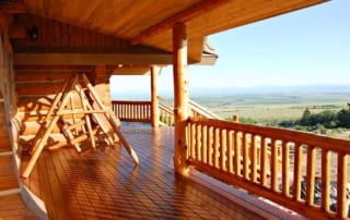 deck with swing and view of hills