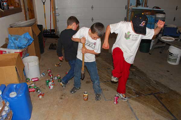 kids crushing aluminum cans