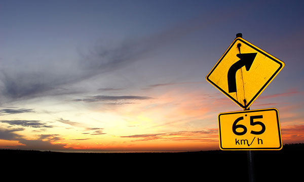 65 MPH Sign against Sunset