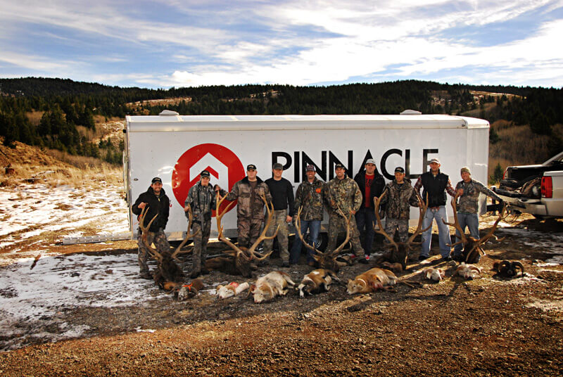 group posing with elk and horns