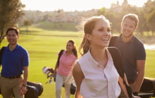 Couples playing golf.