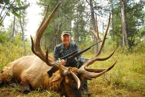 A seasoned sportsman sits behind his bounty thanks in part to his elk hunting gear.