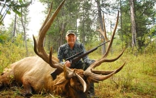 A seasoned sportsman sits behind his bounty thanks in part to his elk hunting gear.