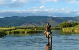 Woman fly fishing in scenic Idaho