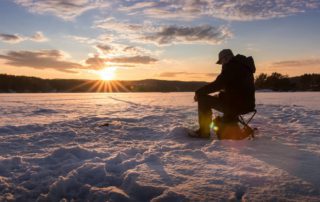 A man ice fishing on a lake in Idaho