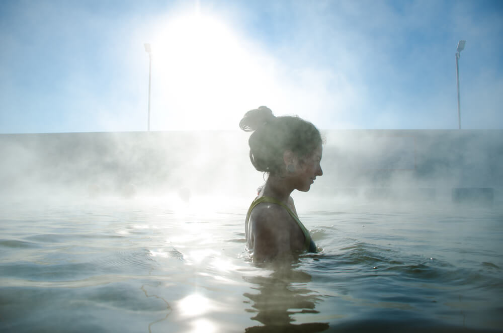 A woman relaxing at Green Canyon Hot Springs