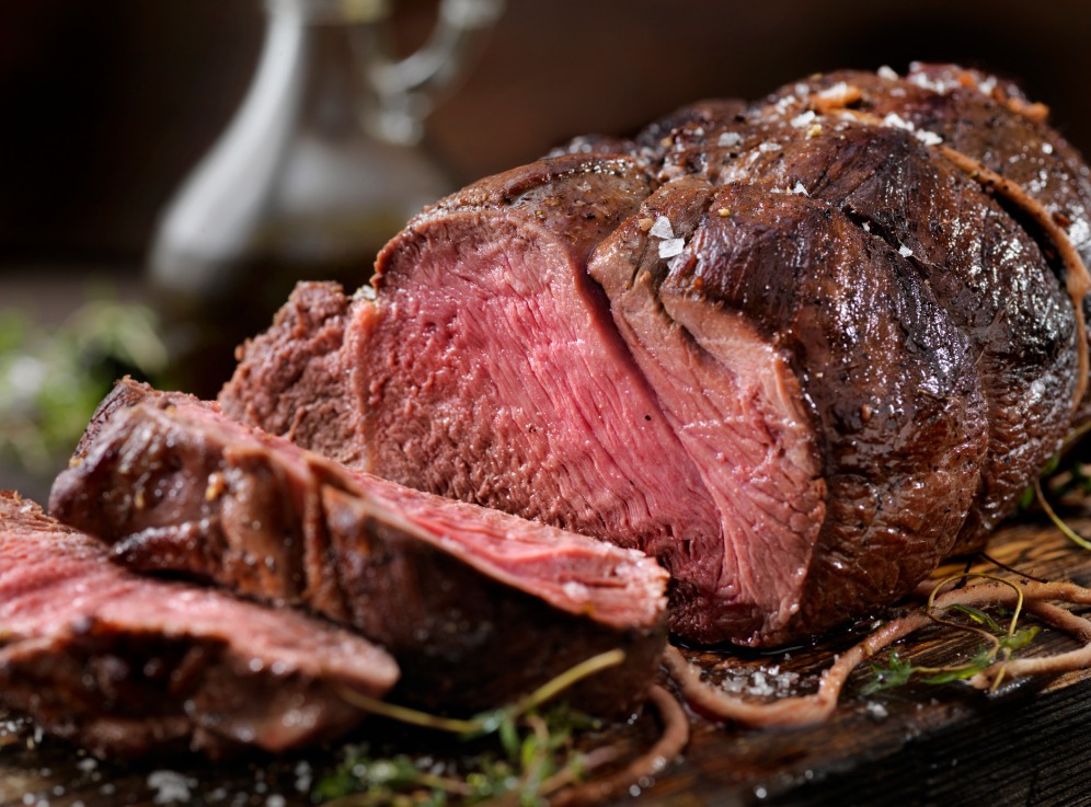 Wild Game Meat: A close-up view of a freshly-grilled, medium-rare elk steak.