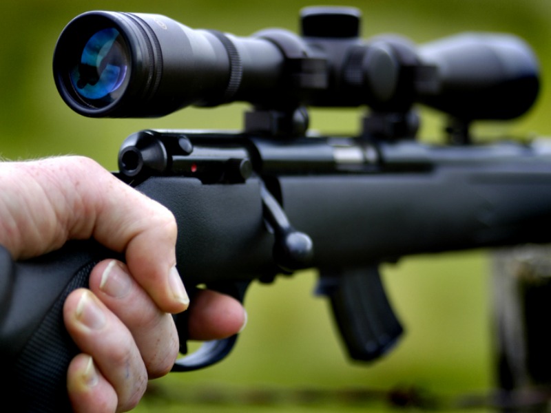 Elk Hunting Gear: An up close view of a black rifle with a scope.